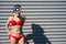 Portrait of a woman in a red bikini holds a megaphone on the background of the face. A girl in a swimsuit makes an