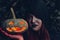 Portrait woman scary ghost in forest he has holding pumpkin