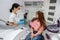 portrait of woman sitting in dental chair and smiling at doctor during consultation in clinic.