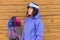 Portrait woman with snowboard and hat and splitboard near wooden wall