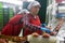 Portrait of woman sorts peaches on a fruit packing line