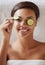 Portrait, woman and spa with cucumber, skincare and smile for facial, relaxation and wellness. Detox, self care and