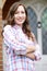 Portrait Of Woman Standing Outside Front Door Of Home