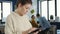 Portrait of woman in startup office picking up tablet with business charts and interacting with touchscreen