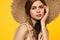 Portrait woman in straw hat on yellow background cropped view of summer dress model pigtails romance