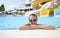 Portrait of woman in sunglasses in water park in pool