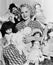 Portrait of a woman surrounded by dolls and smiling