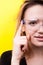 Portrait of woman touching a button on futuristic smartglasses