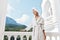 Portrait woman with a towel on my head in a white bathrobe staying on the balcony in a hotel Mountain View