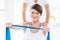 Portrait of woman with trainer holding resistance band