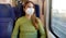 Portrait of woman traveling on public transport wearing protective medical mask. Banner cropped photo of girl with face mask