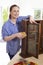 Portrait Of Woman Upcycling Wooden Cabinet At Home