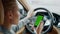Portrait of woman using greenscreen phone at car. Woman holding smartphone