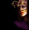Portrait of woman in violet party mask