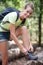 portrait woman walker tying shoelace in forest