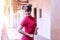 Portrait woman wear cheongsam red dress holding a fan looking at something. Festivities and Celebration concept
