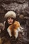 Portrait of a woman wearing fur hat and fox fur pelt on her shoulders.Shot in forest surroundings.