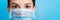 Portrait of a woman wearing medical mask with pandemic word at blue background. and healthcare concept