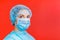 Portrait of a woman wearing medical uniform and mask with epidemic word at red background. concept. Respiratory