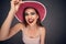 Portrait of woman wearing red summer hat.