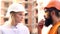 Portrait woman worker and engineer under inspection and checking production process on factory station. Builders