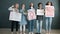 Portrait of women feminists holding gender equality posters and screaming in megaphone