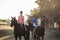 Portrait of women with trainer riding horse