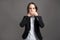 Portrait of wonderful young business woman covering mouth like mute concept, poseing on isolated gray background