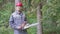 Portrait of worker in a helmet with a chainsaw in the forest