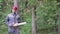 Portrait of worker in a helmet with a chainsaw in the forest