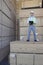 Portrait of a worker standing on stack of plywood