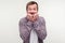 Portrait of worried bearded man looking scared nervous biting his nails, psychological problems. studio shot, white background