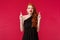 Portrait of worried hopeful redhead woman in black elegant evening dress, cross fingers for good luck, panicking and