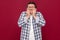 Portrait of worried nervous or stressed middle aged business man in casual checkered shirt and eyeglasses standing, bitting his