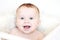 Portrait of yawning baby in red knitted hat