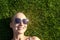 Portrait young adult bald shaved beautiful caucasian woman enjoy having fun lying on green grass lawn and smiling