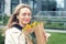 Portrait young adult smiling classy woman model hand holding authentic fresh orange spray roses flower bouquet wrapped