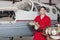 Portrait of young aeronautic engineer standing in front of an airplane propeller