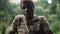 Portrait of young African American man in khaki T-shirt looking at camera with serious facial expression as live camera