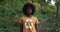 Portrait of young afro american woman wearing t shirt with recycling symbol on it looking to camera. Millennial female