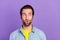 Portrait of young amazed smiling guy looking copyspace see advertisement isolated on violet color background