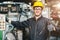 Portrait of young American happy worker enjoy happy smiling to work in a heavy industrial factory.Thumb up with machine controller