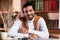 Portrait Of Young Arab Teacher Sitting At Workplace Indoors