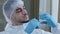 Portrait of young arabic hispanic male doctor nurse in medical cap and latex gloves holding syringe in hand preparing to