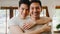 Portrait Young Asia Gay couple feeling happy smiling at home. Asian LGBTQ men relax toothy smile looking to camera while hug in