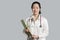 Portrait of a young Asian female doctor with a clipboard over gray background