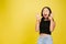 Portrait of young asian girl isolated on yellow studio background