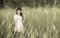 Portrait of young asian girl standing in the middle of grass