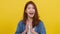 Portrait young Asian lady with positive expression, joyful and exciting, dressed in casual cloth and looking at camera over yellow