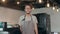 Portrait young Asian man barista feeling happy smiling at urban cafe. Small business owner Japanese male in apron relax toothy